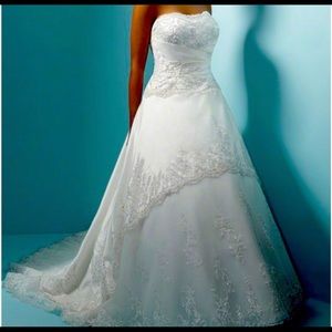 Alfred Angelo cream colored strapless wedding dress.